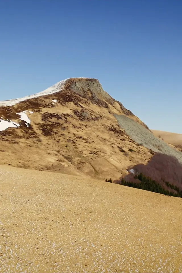 A volcanic summit dusted with snow, in Auvergne