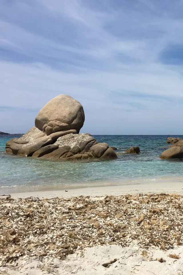 Granite boulders on a Corsican beach, facing a turquoise sea