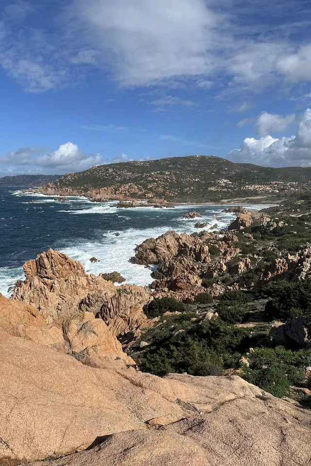 Pink granite rocks and a rough sea on the west coast of Sardinia